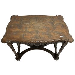 19th century walnut centre table, shaped top carved with central cartouche and extending scrolled foliage, the shaped frieze rails carved with scrolling acanthus leaves, turned supports with central end supports carved with flower heads and scrolls, curved x-framed stretcher carved with a central mask depicting a girl in a bonnet, on turned and carved feet