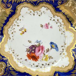 Pair of early 19th century plates, each painted with summer flowers within gilt fan shaped reserves, against a blue scale ground, unmarked, D19cm, together with a 19th century English porcelain plate, pattern no. 2/1078 (3)