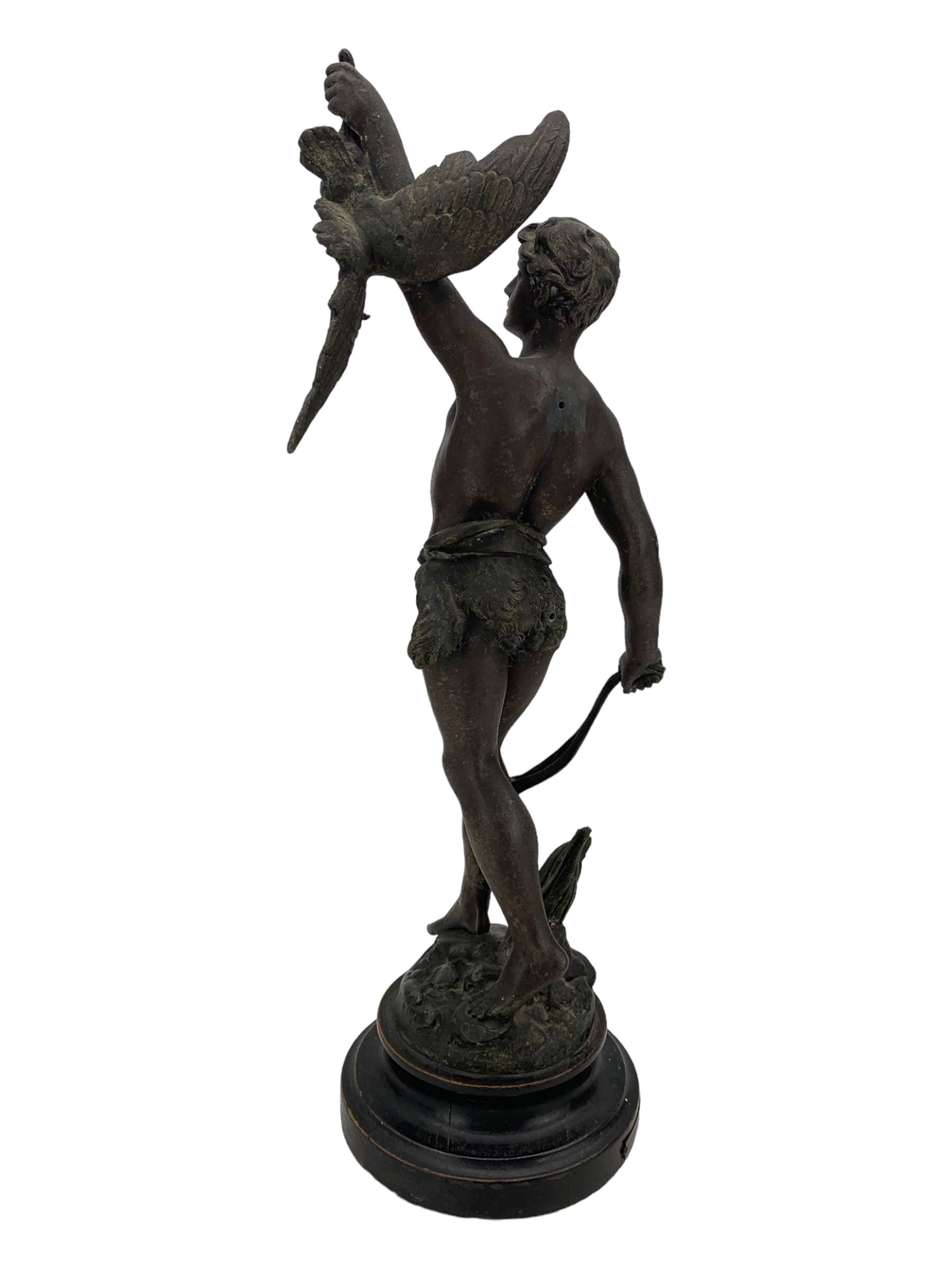 19th century French spelter figure 'Chasseur D'Aigles' on wooden base H48cm and a beaten copper circular tray inscribed with initials D61cm