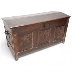 18th century carved oak coffer or chest, sloped hinged lid over panelled front, carved with three Northern European portraits with foliage surrounds decorated with birds, fitted with wrought metal carrying handles, on fluted stile supports 