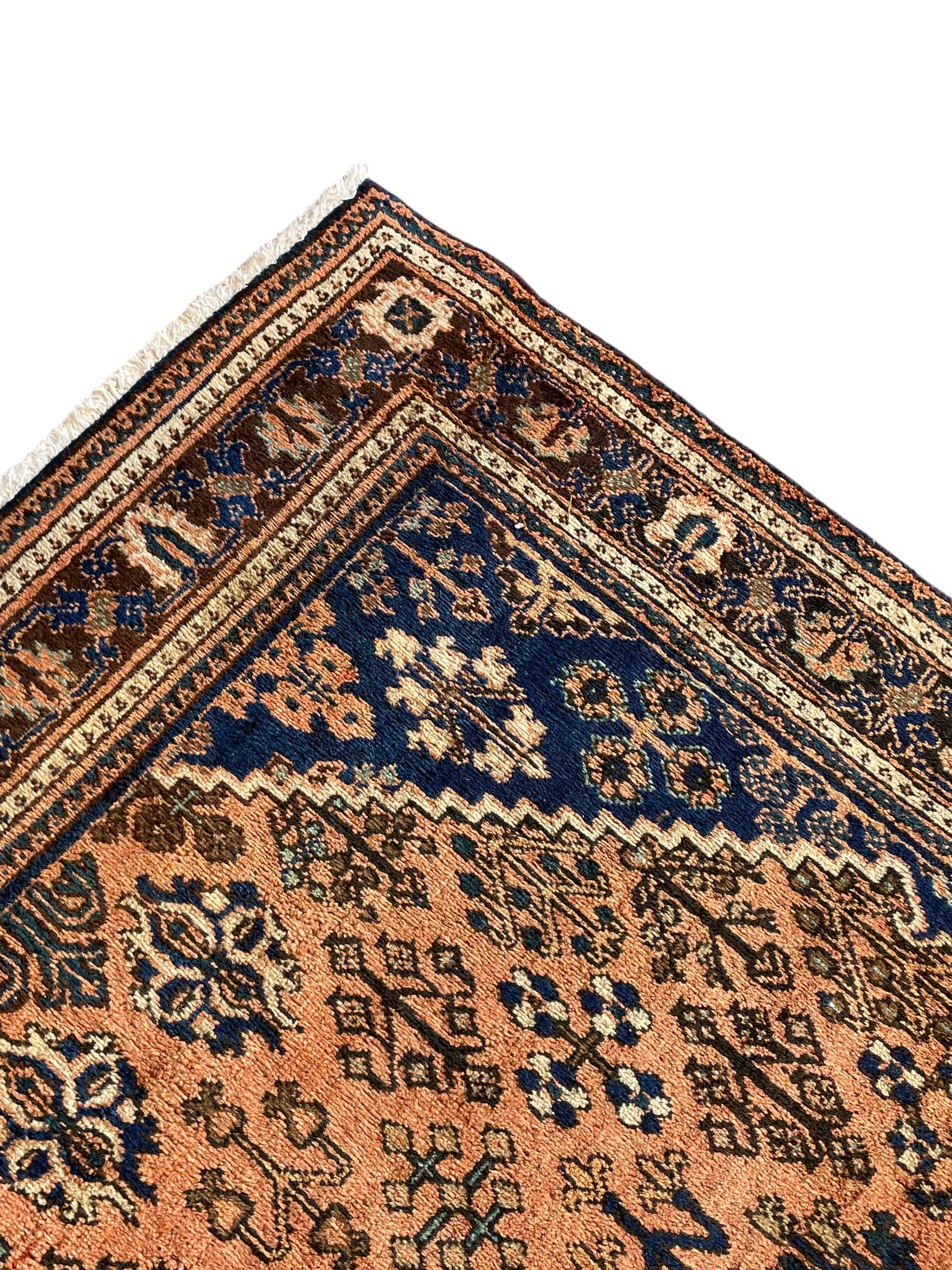 Persian Joshaghan peach and blue ground rug, central stepped lozenge medallion surrounded by bunches of floral motifs, repeating border decorated with stylised plant motifs, within multiple guard stripes