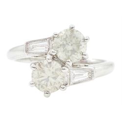 18ct white gold two stone round brilliant cut diamond crossover ring, with tapered baguett...