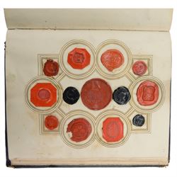 Victorian album of crests and monograms, including examples cut from envelopes and stamped into wax seals, with label to interior front cover reading 'Edward Law's Crest Collection Album 243' 