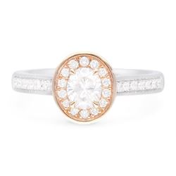 18ct white and rose gold diamond halo cluster ring, the principal oval cut diamond of approx 0.45 carat, with round brilliant cut diamond surround and diamond set shoulders, hallmarked, total diamond weight approx 0.70 carat