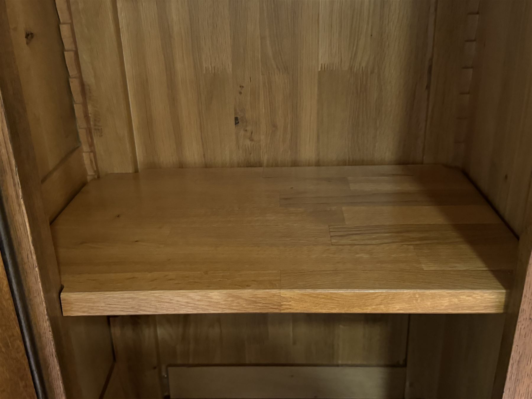 Large 20th century oak dresser, projecting cornice over open arched central section with two shelves, flanked by two panelled cupboards with two shelves, lower section with three drawers above three cupboards, on stile supports 