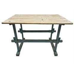 Early 20th century pine rustic dining table, rectangular plank top with weathered patina, over trestle-style supports in distressed blue paint with central stretcher