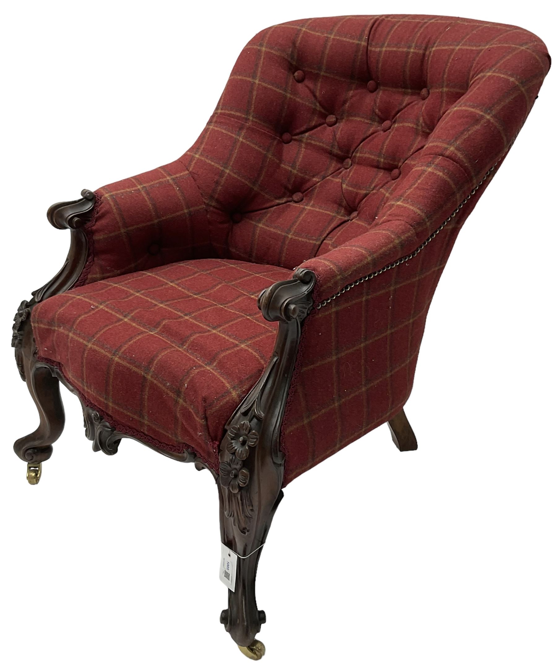 Victorian rosewood framed armchair, upholstered in buttoned tartan fabric, scrolled arm terminals graduating into cabriole supports with moulded flower head decoration and cartouche carved apron, over scroll feet with brass castors