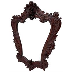 Large carved hardwood wall mirror, shaped floral carved pediment over trailing and scrolled foliage decoration, plain mirror plate 