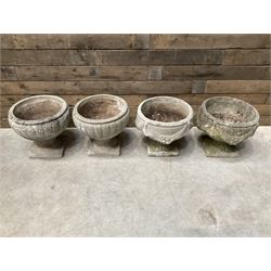 Pair of circular cast stone circular planters, and a similar pair decorated with swags (4)