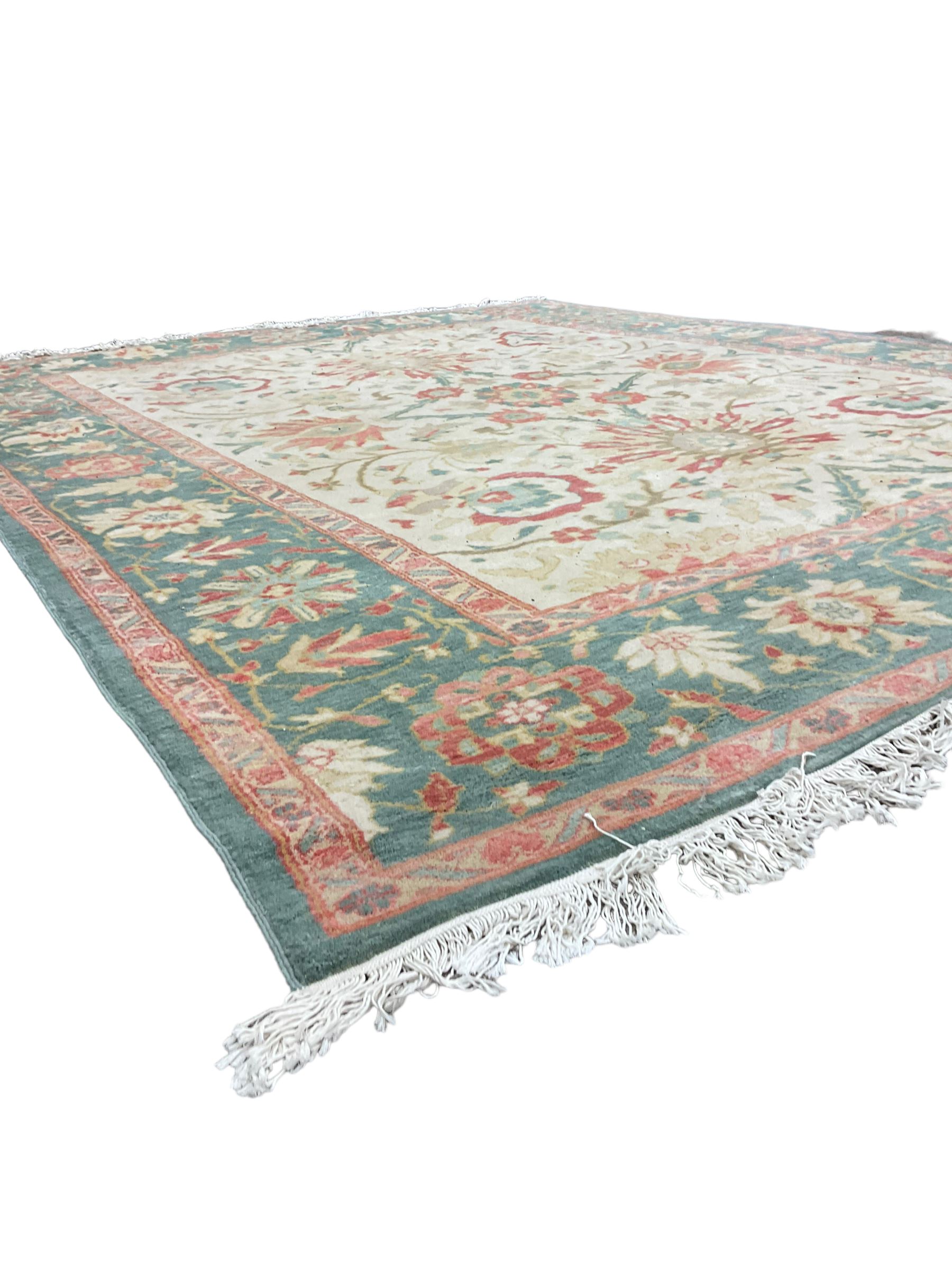 Persian Ziegler design carpet, pale ground field decorated with large stylised plant motifs, the border decorated with large floral motifs within repeating guards