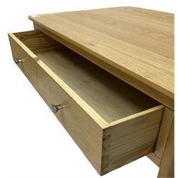 Contemporary light oak rectangular coffee table, fitted with single drawer disguised as two drawers to each side, on tapering supports