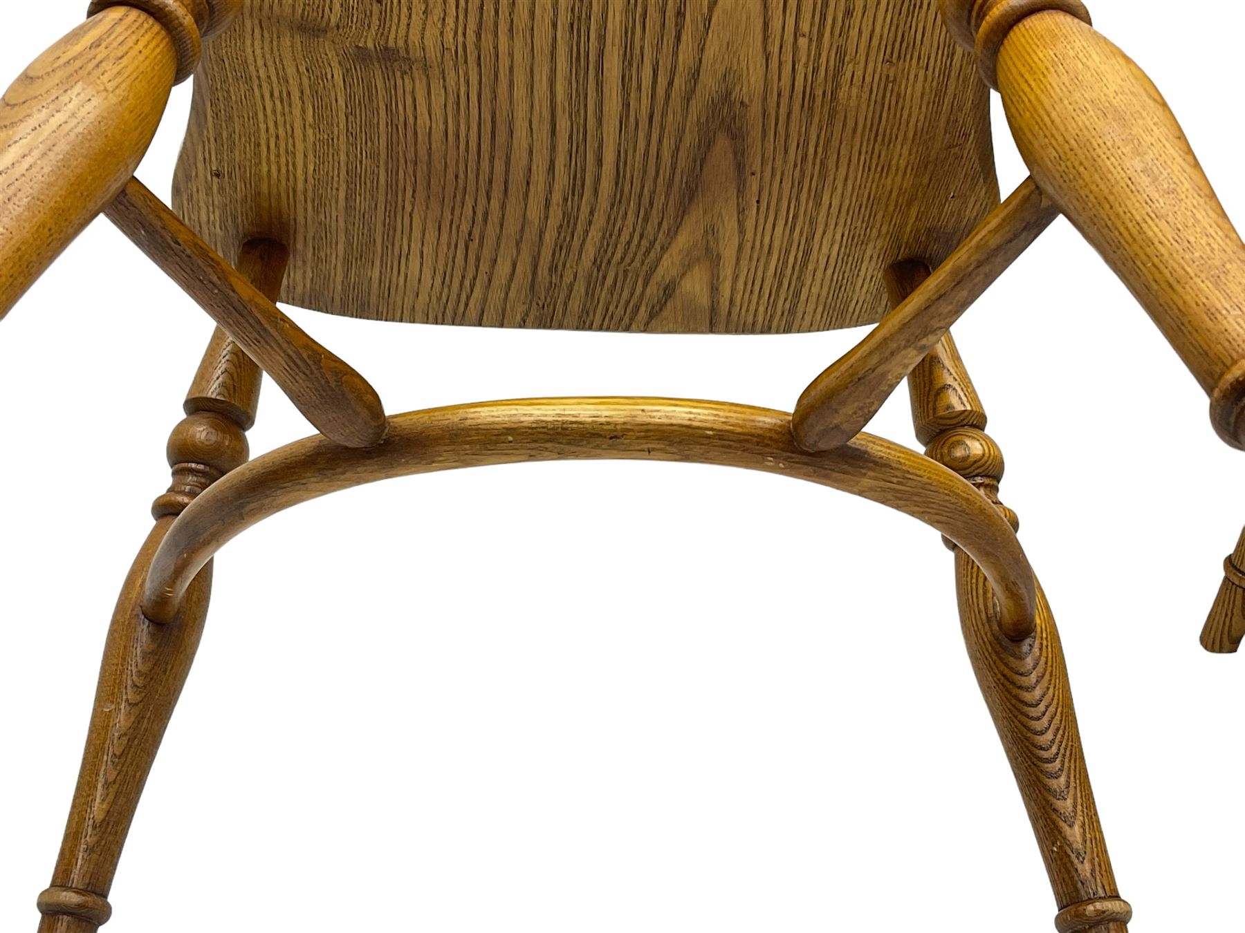 Set of four elm Windsor dining chairs, hoop and stick back with shaped wheel splat, dished seat on turned supports united by crinoline stretcher 