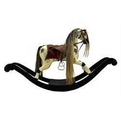 Mid-to-late 20th century carved wooden rocking horse, in dapple grey finish with leather saddle and bridle, mounted on a black painted rocking frame with shaped ends