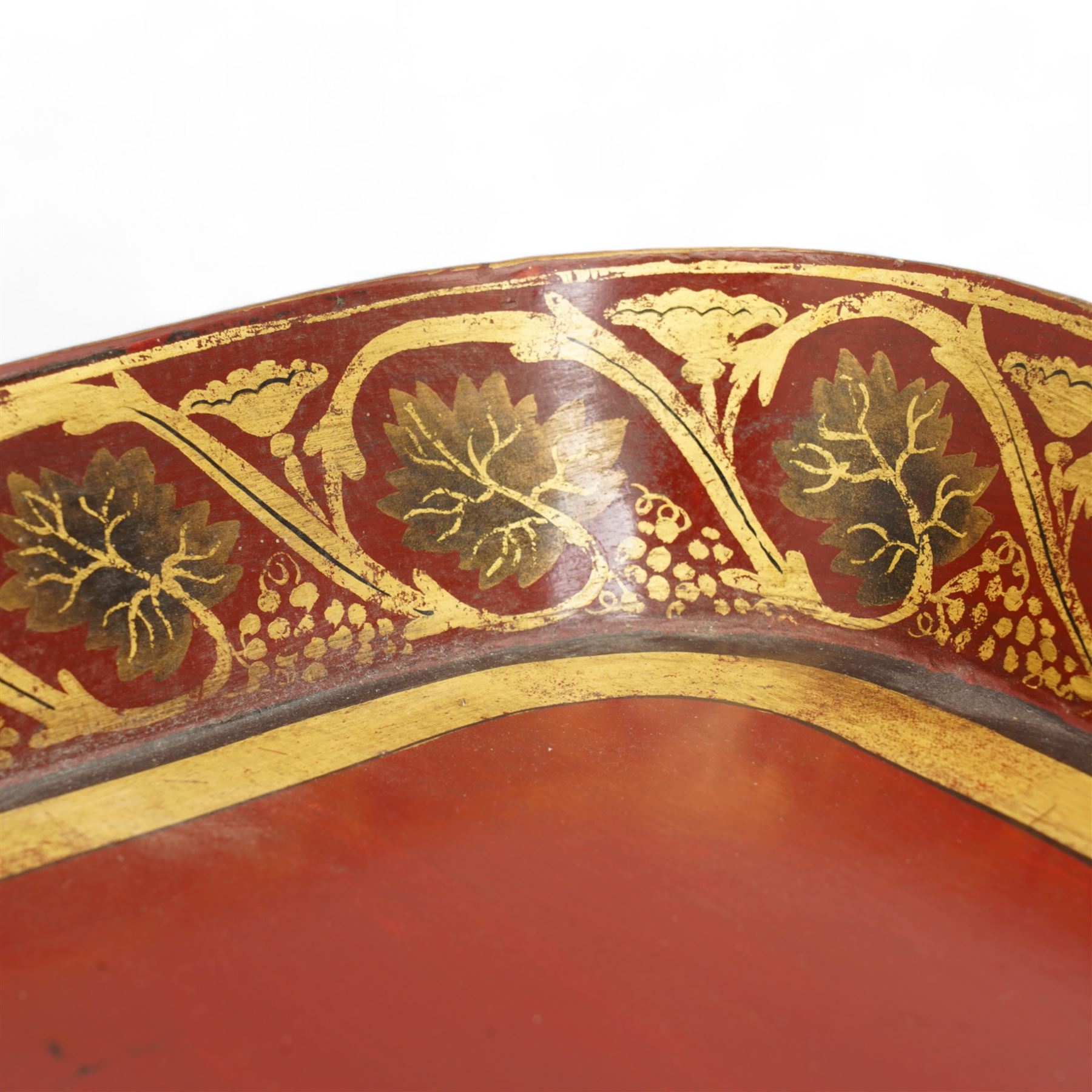 Regency red-japanned and parcel gilt papier-mâché tray, of rectangular form, decorated with a band of leaves and flowers, with trailing foliage to the exterior, L81cm x W59cm