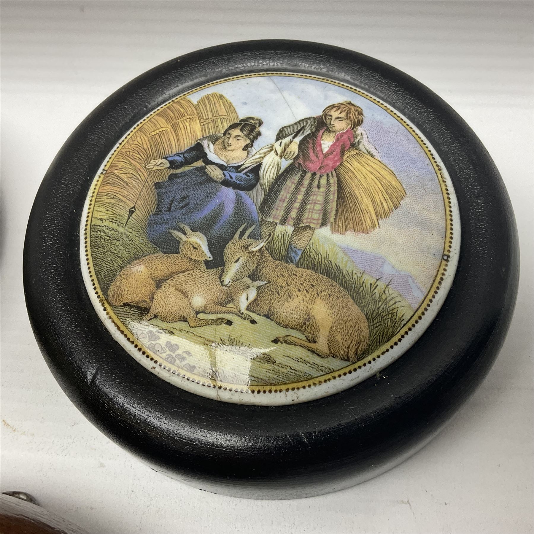 Six framed Prattware pot lids comprising 'Bear, Cock & Lion', 'Bear on Rock', 'Alas! Poor Bruin', ' Lady, Boy and Goats', 'The Shrimpers' and one other, largest D15.5cm (6)