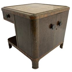 Art Deco period walnut end table, the top inlaid with central shaped panel and extending fan motifs, fitted with two drawers, double cupboard and shelves, on bracket feet