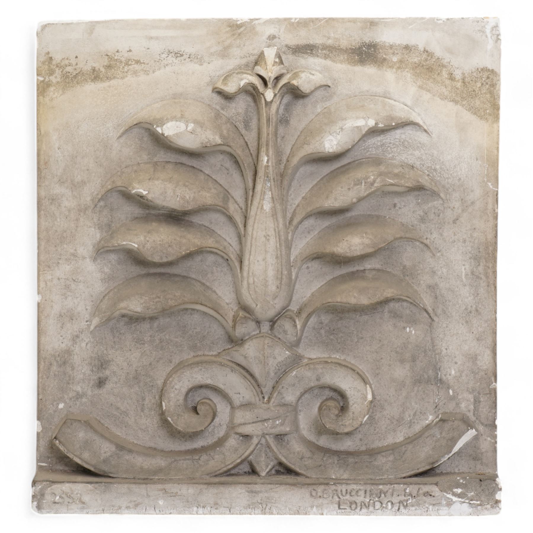 D Brucciani. London - After the Antique - Two Architectural plaster panels decorated with anthemion and acanthus leaves, larger 47cm x 32cm, a plaster pinnacle also by Brucciani No.3149 64cm x 24cm and a composition dolphin (4)