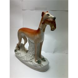 Pair of standing Staffordshire whippets with rabbits in their mouths, together with a pair of Staffordshire spaniels, whippets H30cm