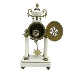 French - early Edwardian 8-day gilt metal and white marble clock garniture c1910, drum head case surmounted by an urn with cast side scrolls, supported by four pillars on a rectangular stepped plinth with recessed feet, white enamel dial with Arabic numerals, garland swags and gilt hands, with a sunburst pendulum and twin-train countwheel striking movement, striking the hours and half hours on a bell. With a pair of three light, two branch candelabra on scroll-cast branches. With key and pendulum.