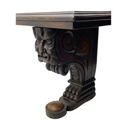 Victorian oak bench, moulded rectangular top, on mask and scroll carved corbel supports with paw feet, rectangular platforms with rounded terminals and applied roundel 