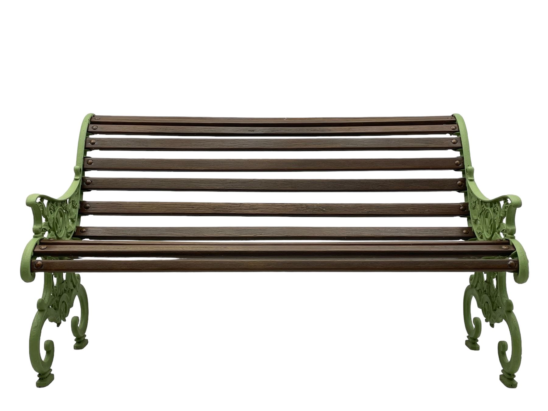 20th century cast iron and wood slatted 'Lilly of the Valley' garden bench, cast iron bench ends of scrolled form decorated with trailing foliage and flower heads, on scrolled supports 