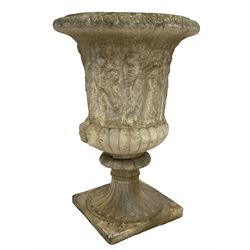 Cast stone Campana shaped urn, decorated with festival scenes over gadrooned underbelly, circular foot on square base