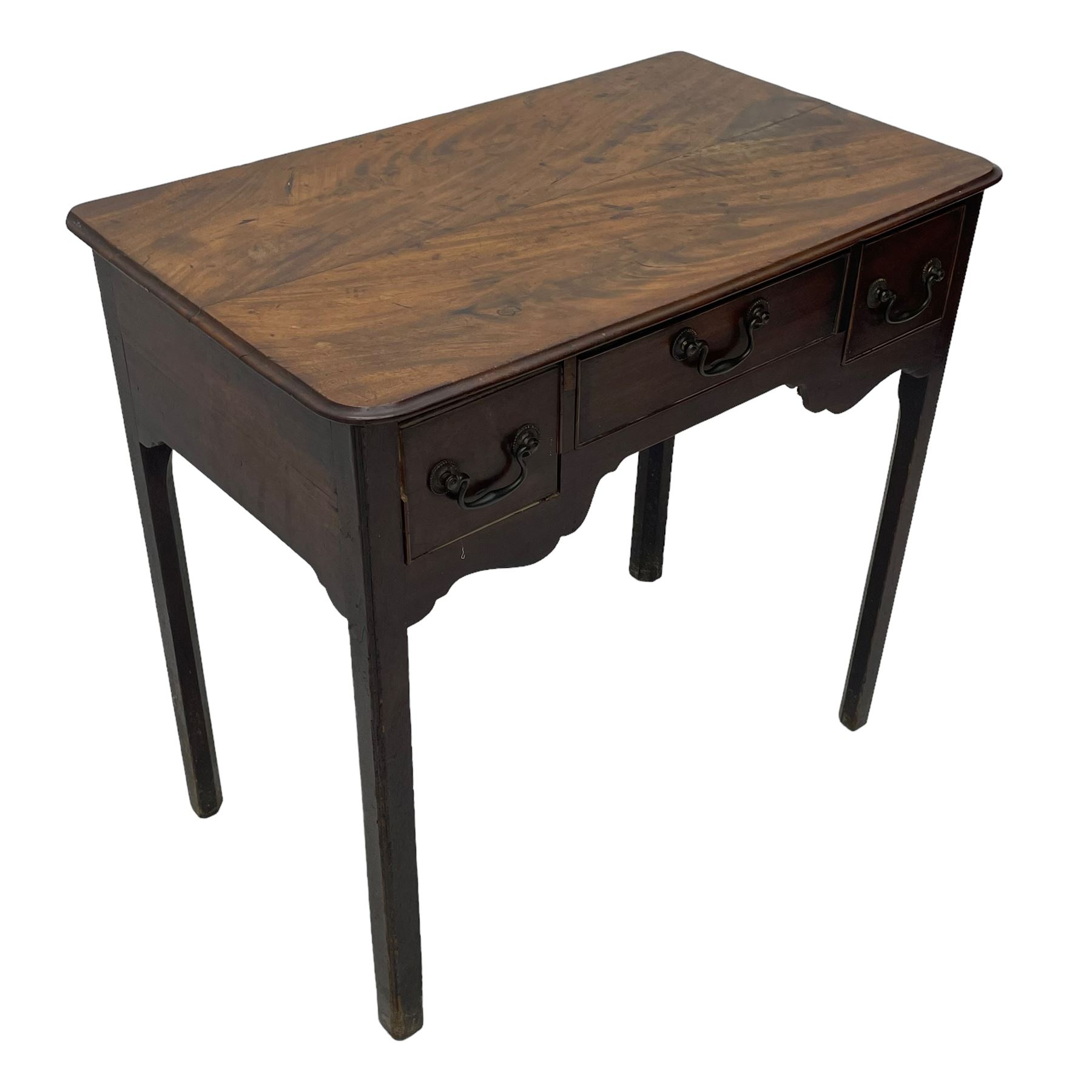 George III mahogany low-boy, moulded rectangular top with rounded front corners, fitted with three cock-beaded drawers, beaded circular brass handle plates and swan neck handles, shaped apron, on square supports with inner chamfer 