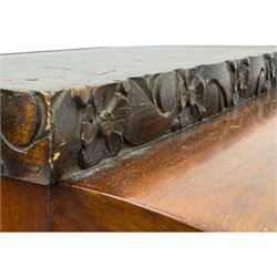 Early 20th century Art Deco walnut display cabinet, with arched top and carved floral crest, central band flanked by two glazed panel doors with decorative mullions, enclosing two glass shelves, on scroll carved bracket feet