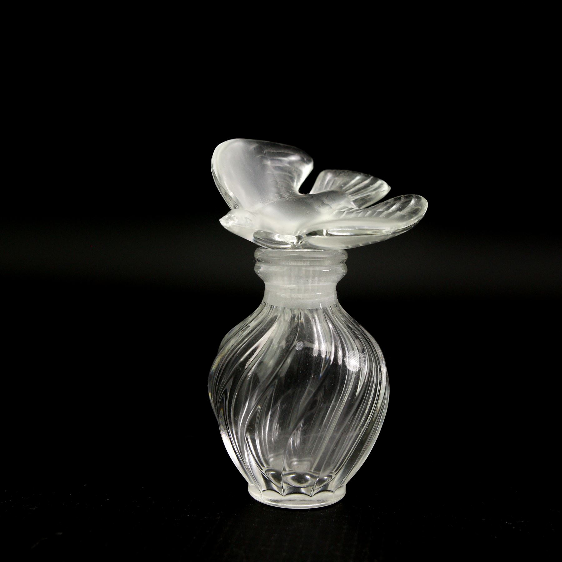 Lalique glass to include three pin dishes surmounted with swans, lovebirds and wren, another figure of a wren on circular base and a Nina Ricci dove perfume bottle, H9cm (5)