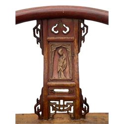 Late 19th century Chinese Qing dynasty horse shoe armchair, in elm, hung mu and Chinese softwood, horse shoe shaped upper rail carved with scroll terminals, shape back carved with solitary figure in robes, rectangular panelled seat in moulded frame, decorated with fretwork panels, on square supports united by stretchers 