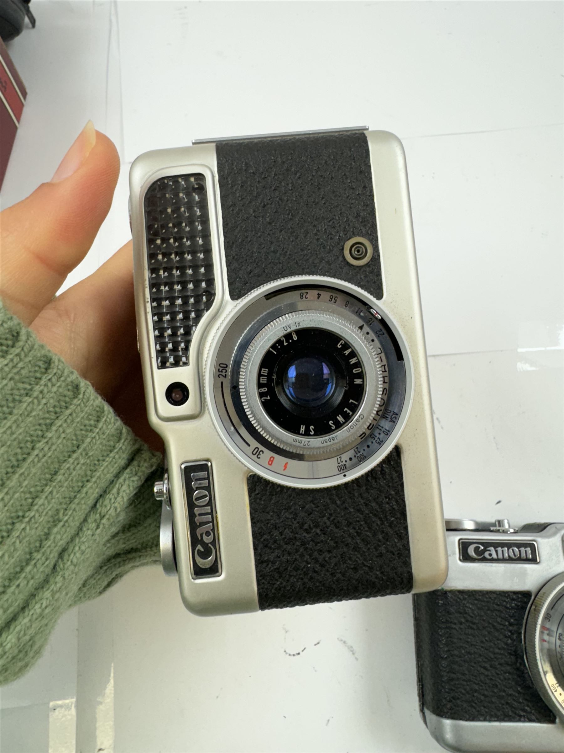 Three Canon half frame cameras, comprising two Canon Demi examples, serial nos. 243090 & 704714, one example boxed, and a Canon Dial35 serial no. 341572