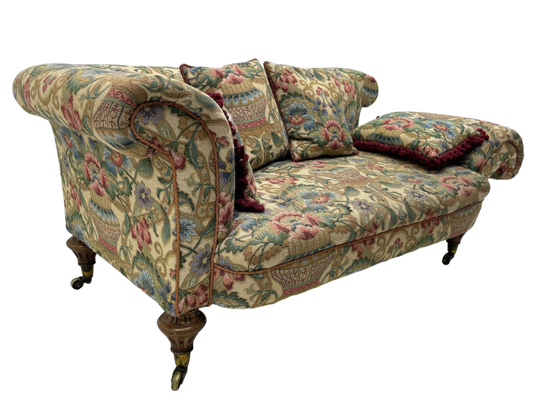 Mid-19th century walnut framed two-seat sofa, rolled arms over sprung seat, single drop-end action, raised on turned and fluted feet with brass cups and castors, upholstered by E & S Gott in traditional floral pattern fabric decorated with urns