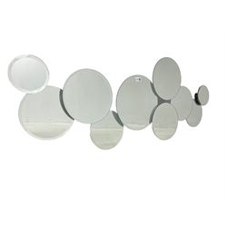 Contemporary abstract circular mirror, comprised of interconnecting bevelled plates of varying sizes