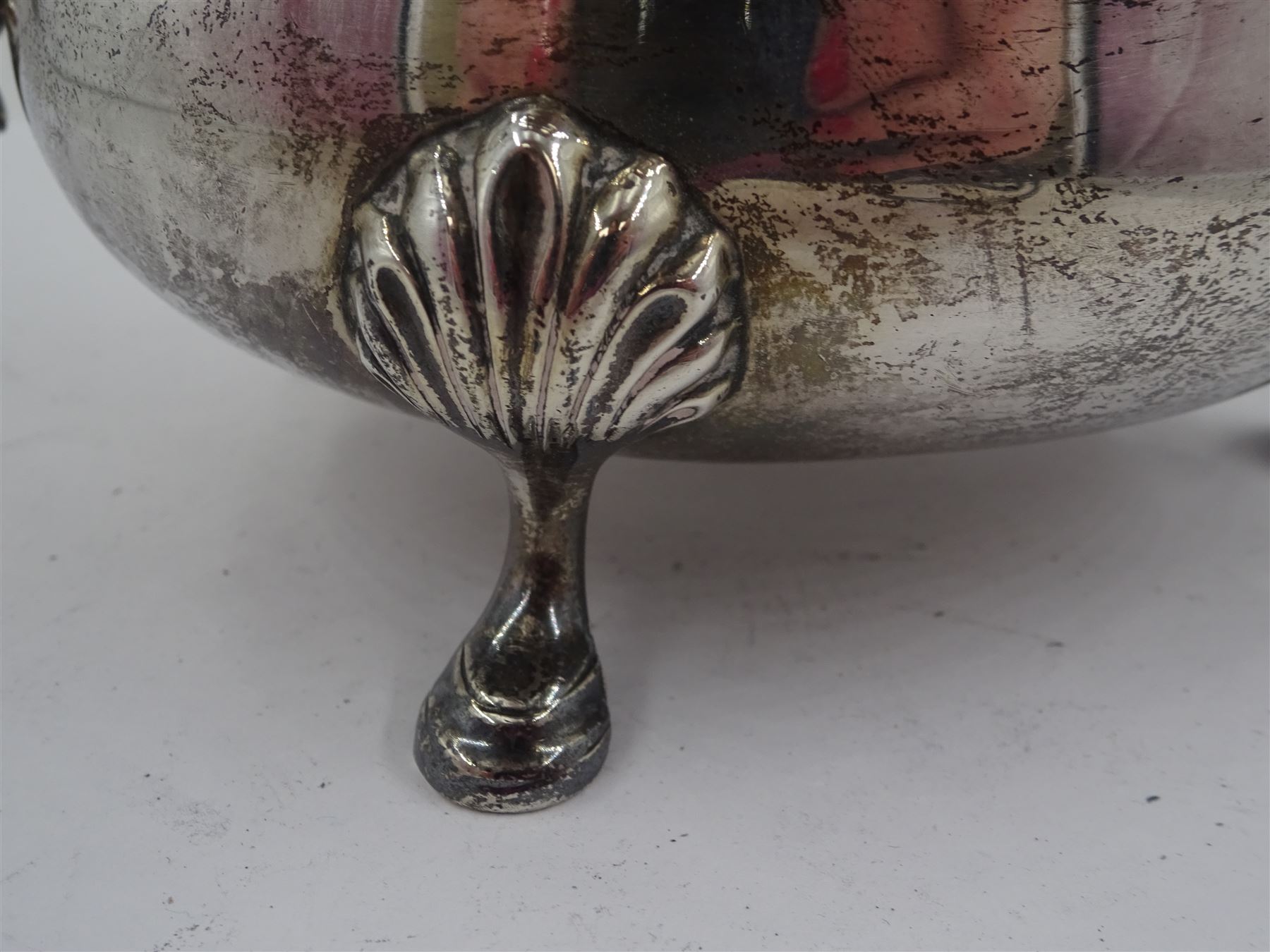 1930s silver sauce boat, of typical form with shaped rim, and acanthus leaf capped flying scroll handle, upon three palmette mounted stepped feet, hallmarked 	Harrods Ltd, London 1934, including handle H10.4cm