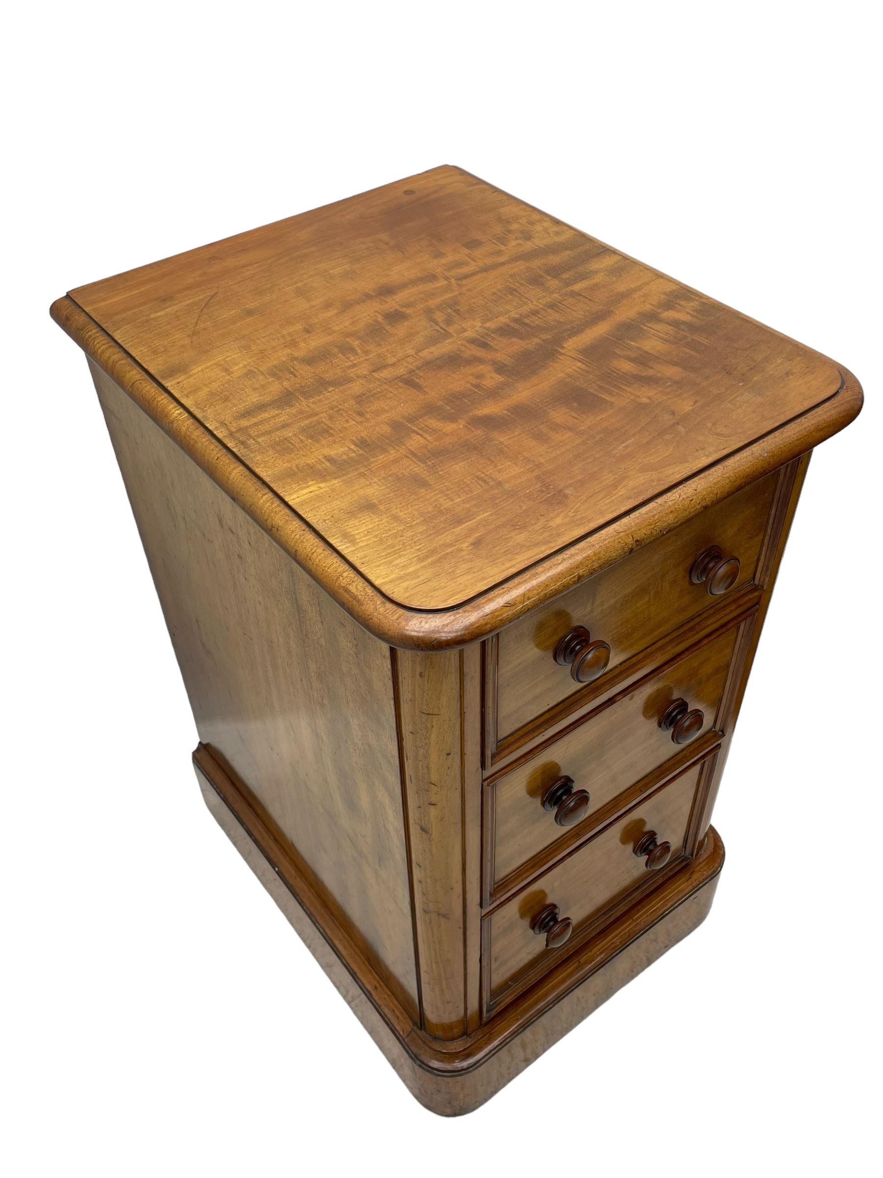 Pair of Victorian figured mahogany pedestal chests, rectangular form with rounded front corners, moulded top over three drawers with applied mouldings and turned handles, on moulded plinth base