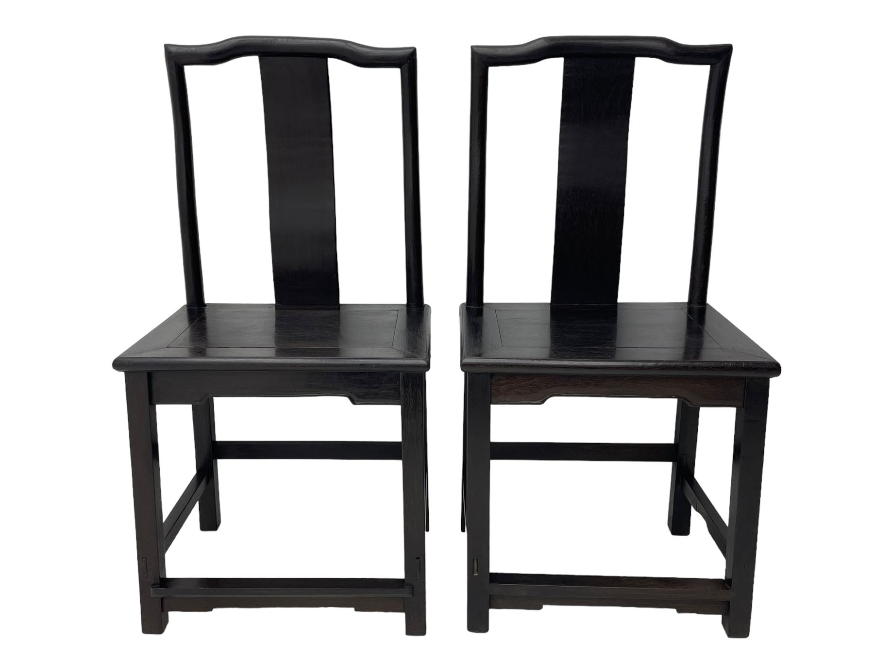 Pair of early 19th century Chinese Qing dynasty black wood side chairs, yoke cresting rail over shaped back panel, panelled rectangular seat on square supports united by stretchers 