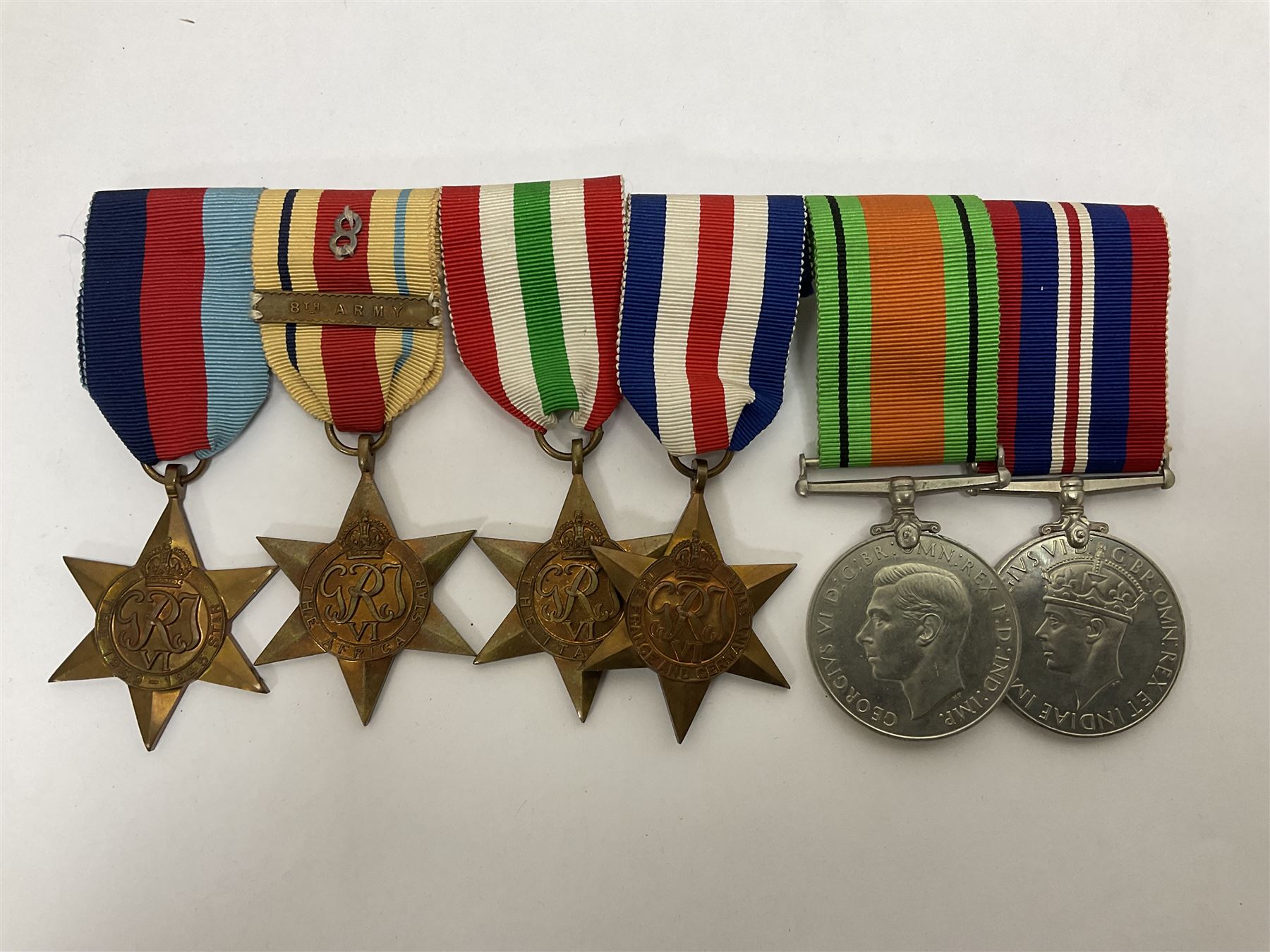 WWII group of six medals comprising 1939-45 Star, The Africa Star, The Italy Star, France and Germany Star, Defence Medal and War Medal 1939-45, awarded to 7899181 RAC C.W Hughes, together with two chevrons and ephemera relating to Charles William 'Bill' Hughes including Soldier's Release Book, photographs, certificates of transfers etc 