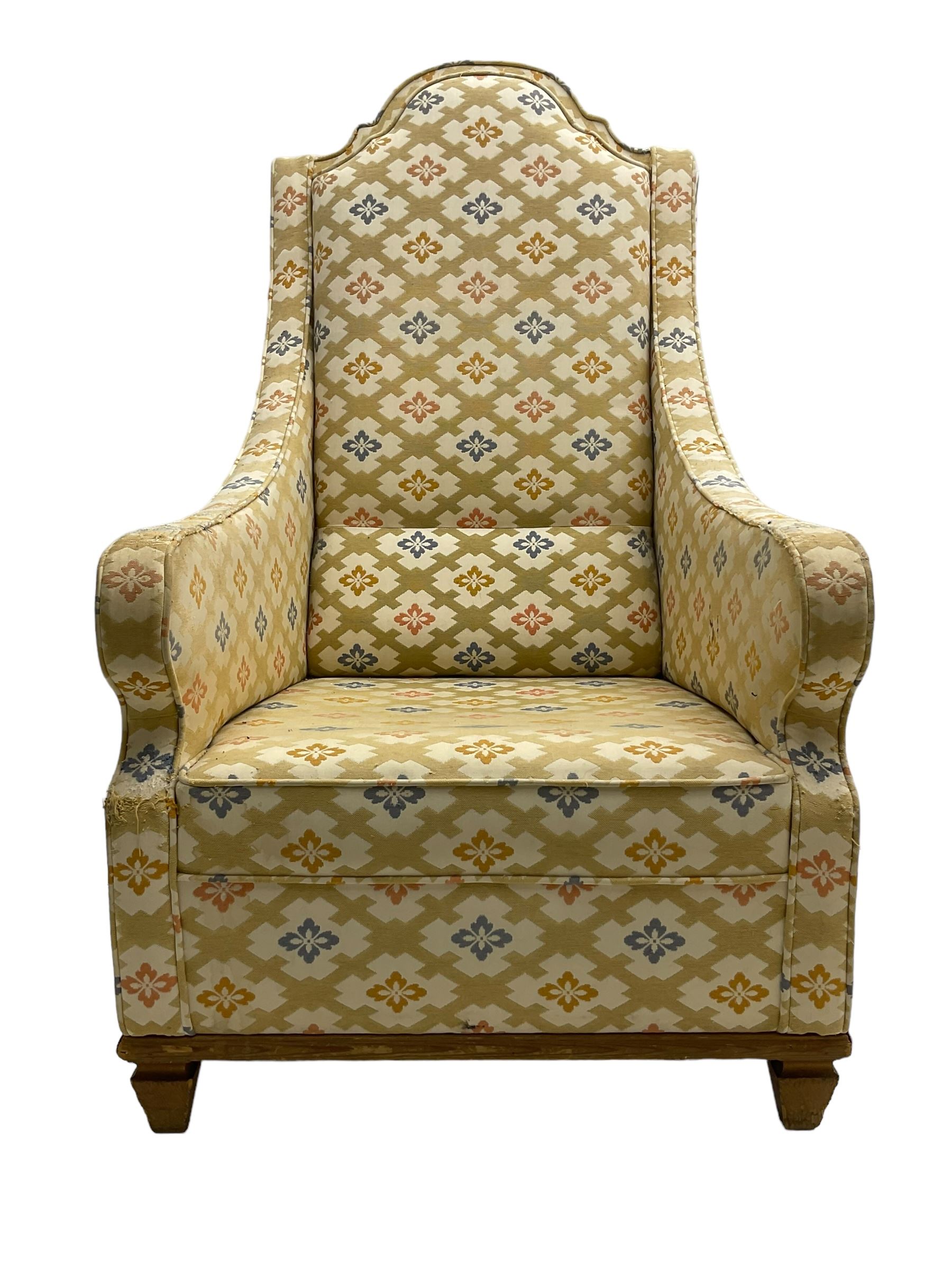 Spanish high back throne armchair, arched cresting rail over scooped arms, upholstered in gold and ivory patterned fabric, on a pitch pine base with spade feet