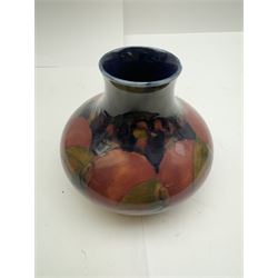 Moorcroft vase of squat form, decorated in Pomegranate pattern on a blue ground, with painted makers mark beath, H13cm 