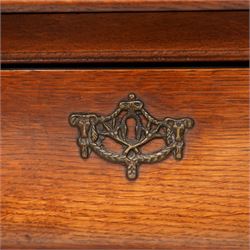 Early 20th century Dutch oak bombe chest, shaped rectangular top with moulded edge, fitted with three drawers flanked by moulded uprights, on hairy ball-and-claw feet