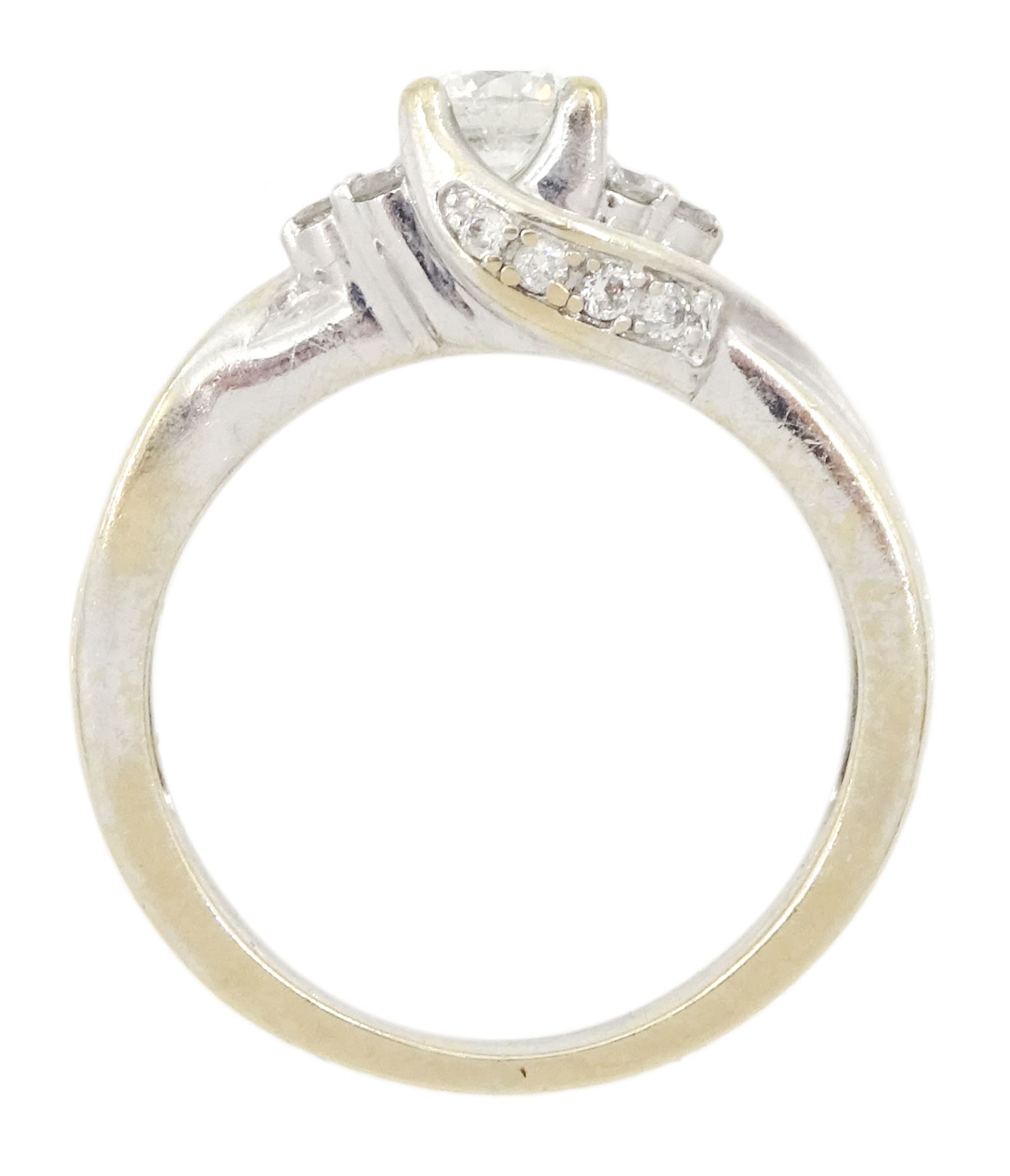 18ct gold round brilliant cut diamond ring, central diamond flanked by groups of smaller diamonds, hallmarked, principal diamond weight approx 0.25 carat