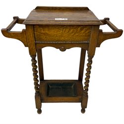 Early 20th century oak work table or hall stand, rectangular top with hinged lid enclosing interior storage, side hanging handles, barley twist supports united by square stretchers, on turned feet