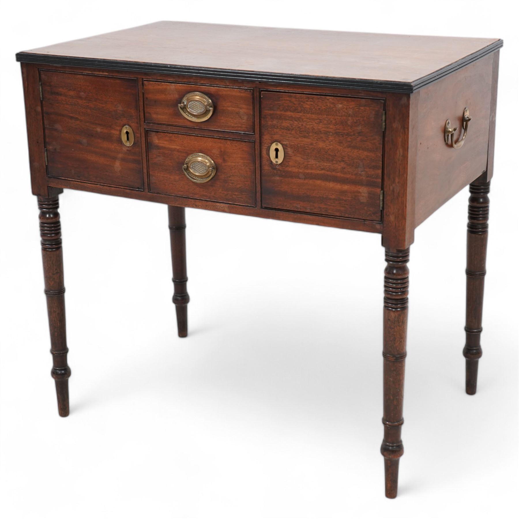 Georgian mahogany side table, rectangular reeded top over two small drawers and flanking cupboards, false drawer to the opposing side, fitted with carrying handles, on ring turned supports