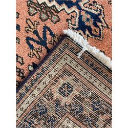 Persian Joshaghan peach and blue ground rug, central stepped lozenge medallion surrounded by bunches of floral motifs, repeating border decorated with stylised plant motifs, within multiple guard stripes