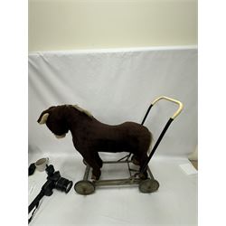 1920s/30s Panurge Pets push-a-long horse, with brown mohair body and white face, horse hair mane and tail and leather hooves, mounted upon a metal with rubber and metal wheels, including handle H71cm