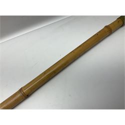 Bamboo cane torch, the pierced brass cover opening to reveal a wick, H144cm