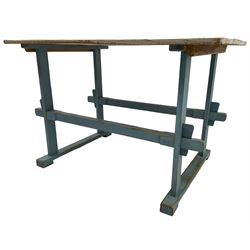 Early 20th century pine rustic dining table, rectangular plank top with weathered patina, over trestle-style supports in distressed blue paint with central stretcher