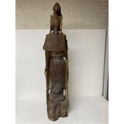 Composite figure of Guanyin standing on rocky ground, with gilt detailing, H104cm