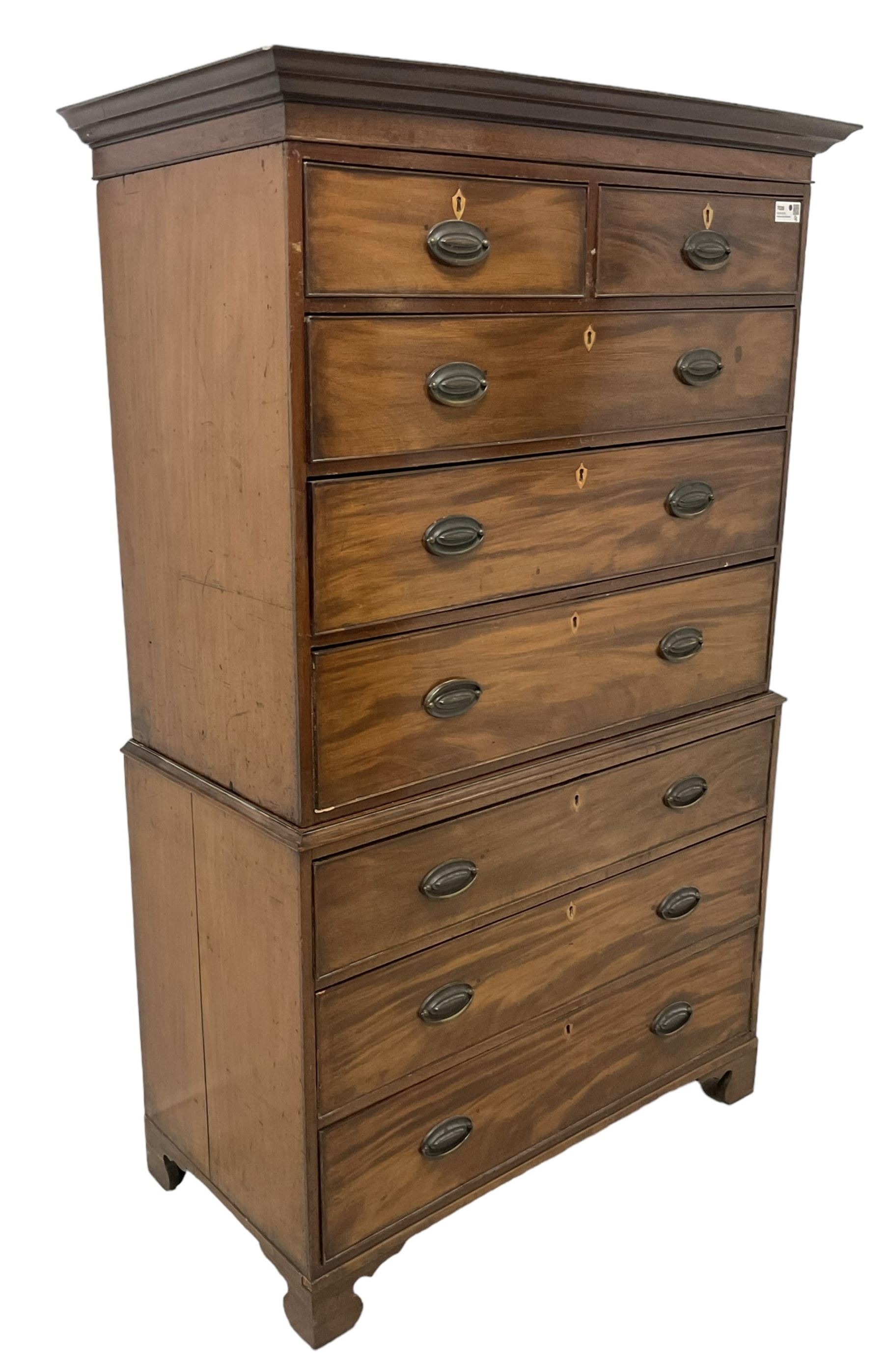 Early 19th century mahogany chest-on-chest, projecting cornice over banded frieze, fitted with two short over six long graduating cock-beaded drawers with bone and timber escutcheons, on bracket feet