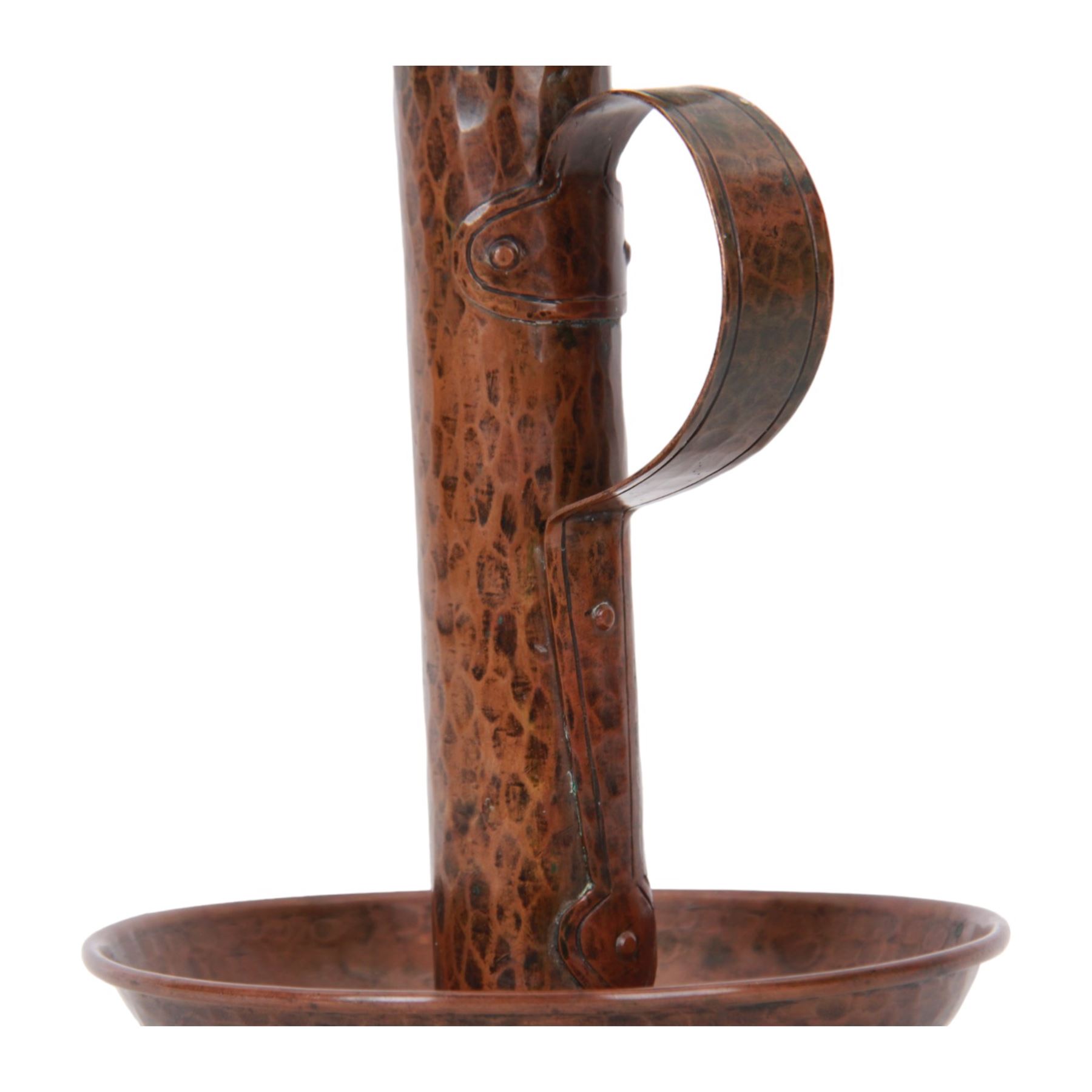 Large Arts & Crafts copper chamberstick, the circular dish with tall cylindrical stem, circular nozzle, and applied strap handle, the whole with hammered finish, with impressed mark beneath, H22cm